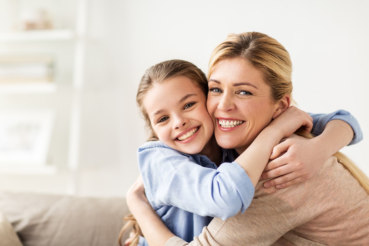 mother and daughter smiling on a couch in clermont florida